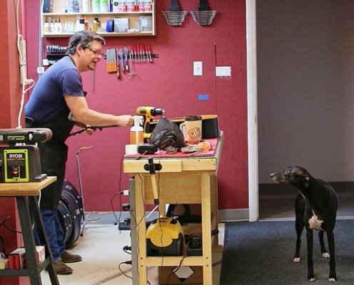 Rick in the shop with Running Dogs mascot Keaton.