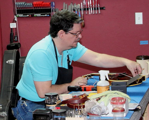 Rick works on a mandolin repair.